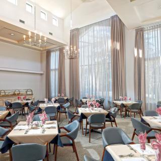 A modern and elegant restaurant dining area with well-arranged tables and chairs.