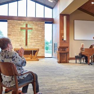 A serene moment of worship in a church setting, with members gathered for music and prayer.