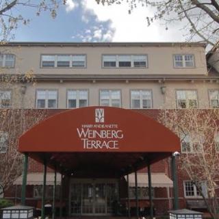 The entrance of Weinberg Terrace, a residential building featuring distinctive architecture.