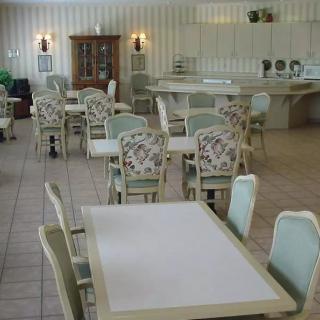 An empty dining area with tables and chairs arranged neatly.