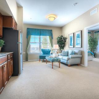 A bright and cozy living room with a comfortable sofa, elegant curtains, and neatly arranged furniture.
