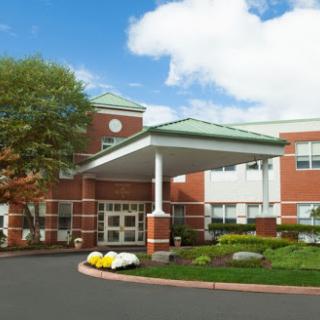 A welcoming healthcare facility with a well-maintained entrance and landscaped surroundings.
