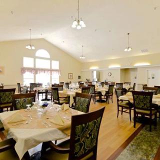 A spacious dining room with neatly arranged tables and chairs.