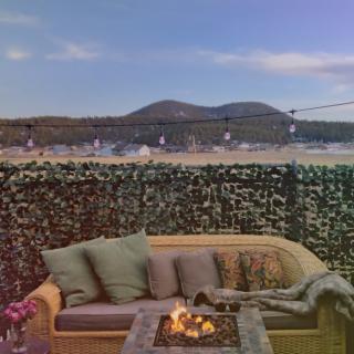 Cozy outdoor seating area with a fire pit and mountain view.
