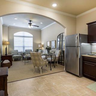 An open-plan kitchen and living area with modern furnishings and a cozy dining space.