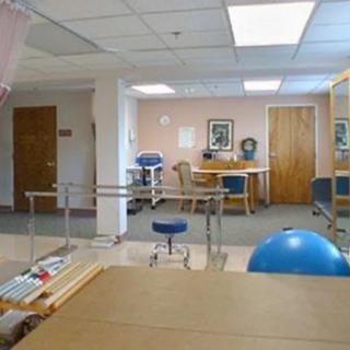 A rehabilitation room equipped with various physical therapy tools and exercise equipment.