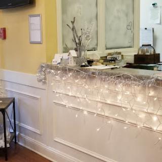 A cozy caf interior featuring soft lighting and a well-decorated counter.