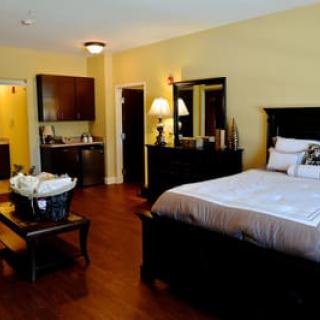 A cozy and well-furnished bedroom with a large bed and stylish decor.