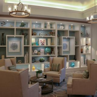 A modern living room with comfortable seating and stylish bookshelves.