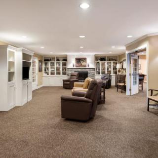 Spacious living room with comfortable seating and built-in bookshelves.