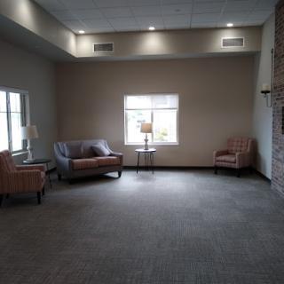 A spacious lounge area featuring comfortable seating and natural light.