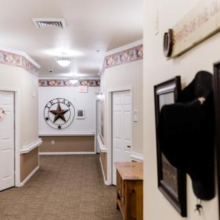 A hallway decorated with a cowboy hat and star-themed wall art.