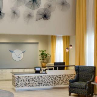 A modern hotel lobby with stylish decor and comfortable seating.