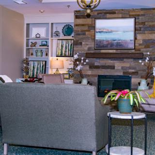 A cozy living room with modern decor, featuring a stylish couch, decorative plants, and a beautifully arranged bookshelf.