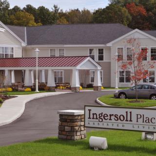 Exterior view of a building with a driveway and sign reading 'Ingersoll Place'.