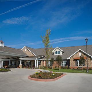 A spacious and well-maintained building under a clear blue sky.