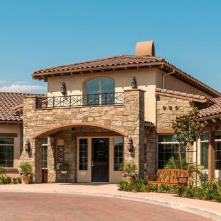 A beautiful residential building with a stone facade and tiled roof.