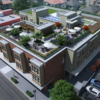 A modern building with a rooftop garden, showcasing urban architecture from an aerial view.