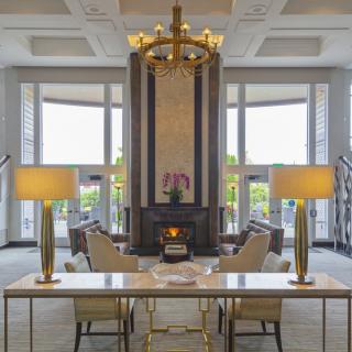 Elegant hotel lobby featuring a grand chandelier and comfortable seating area.