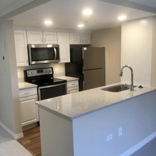 A modern kitchen with stainless steel appliances and a sleek countertop.
