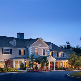 A charming residential building illuminated during the evening.