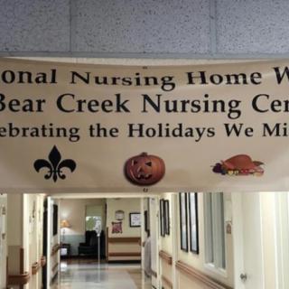 A banner in a hallway celebrating various holidays at Bear Creek Nursing Center.