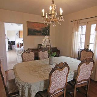 Elegant dining room with a chandelier and a traditional table setting.
