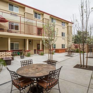 Outdoor courtyard area with tables and chairs in an apartment complex.