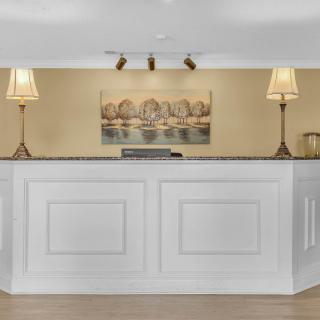 A well-lit hotel reception area with elegant decor and a welcoming desk.