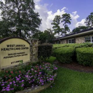 West Jarnich Healthcare Center with surrounding greenery and flowers.
