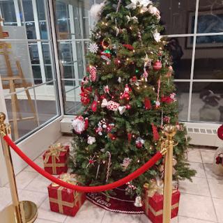 A beautifully decorated Christmas tree surrounded by presents, ready for the holiday season.