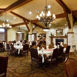 An elegant dining room with beautifully set tables and warm lighting.