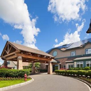 A welcoming entrance to a residential building under a blue sky.