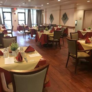 A neatly arranged dining room with tables set for guests.