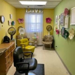 A cozy salon room with colorful walls and eclectic decor.