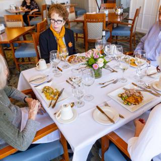 A group of people enjoying a meal together at a restaurant table.