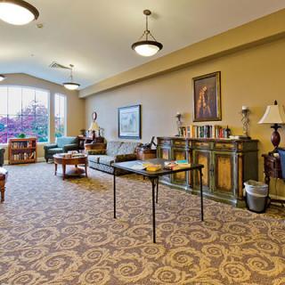 A cozy living room with comfortable seating, tables, and elegant decor.