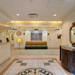 A cozy hotel lobby with elegant lighting and comfortable seating.