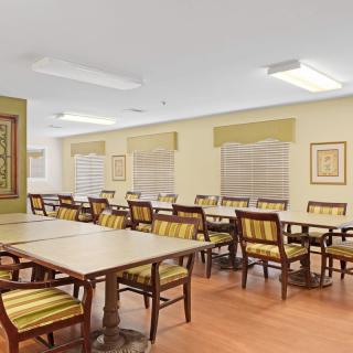 A spacious dining area with multiple tables and chairs arranged neatly.