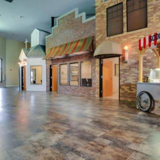 An indoor space resembling vintage storefronts with various architectural designs.