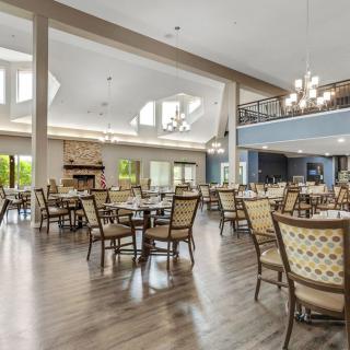 Spacious dining area with elegant chandeliers and ample natural light.