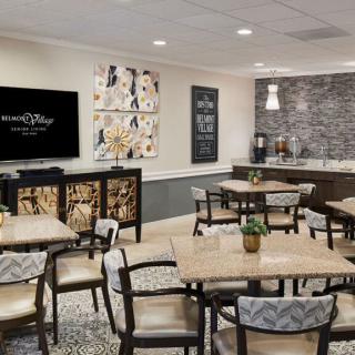 A modern dining area with tables, chairs, and stylish wall decorations.