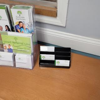 An organized display of brochures and business cards in an office setting.