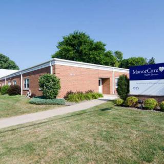 Exterior view of a healthcare facility with a visible sign.