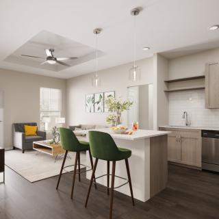 A modern open-concept kitchen and living area with sleek interior design, featuring an island with bar stools and wooden flooring.