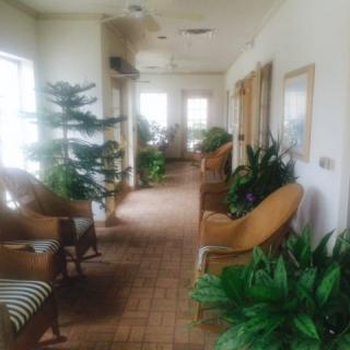 A cozy hallway with ample seating and indoor plants.