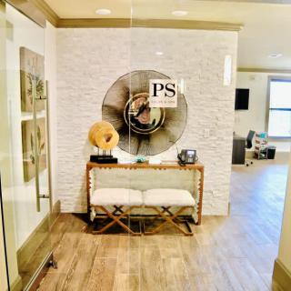 A stylish entrance hall featuring modern decor with a wooden floor and eye-catching wall art.