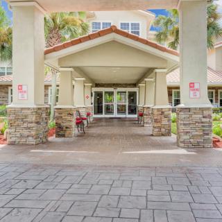 Entrance to a building with stone pillars and a covered porch.