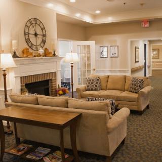A welcoming living room with a cozy atmosphere, featuring comfortable sofas and a fireplace.