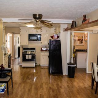 A cozy kitchen and dining area with wood flooring and modern appliances.